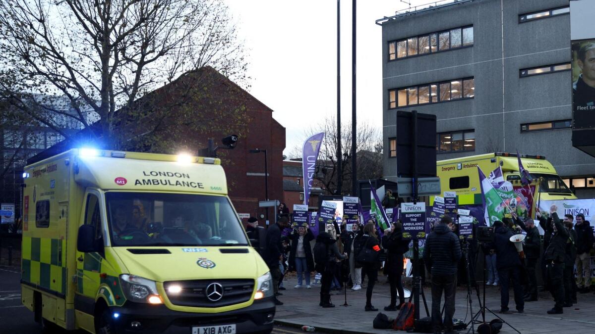 An ambulance on emergency call drives past ambulance workers' strike, amid a dispute with the government over pay, outside NHS London Ambulance Service in London on December 21, 2022. — Reuters