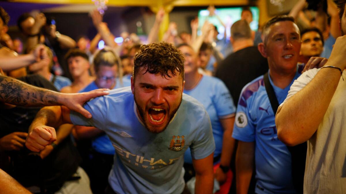 Manchester City fans celebrate after winning the Champions League.
