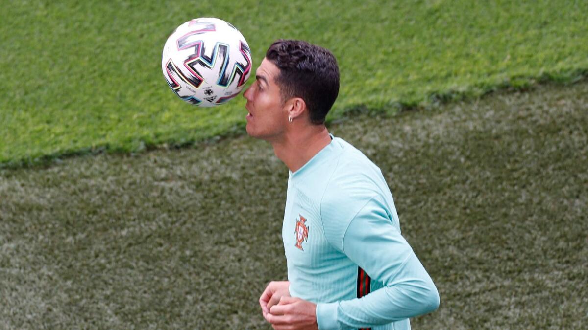 Portugal's forward Cristiano Ronaldo juggles the ball during a training session at the Illovsky Rudolph Stadium in Budapest. — AFP