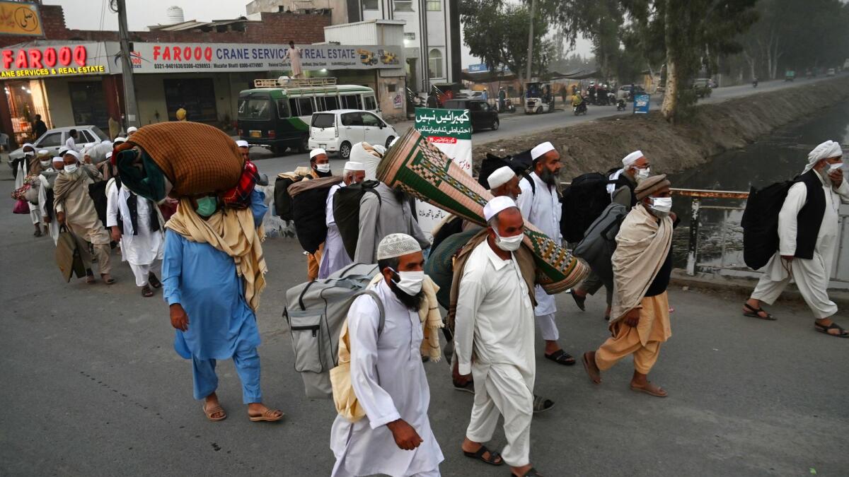 Pakistani Muslims wearing facemasks as a preventive measure against the Covid-19 coronavirus arrive for the annual Tablighi Ijtema religious gathering in Raiwind on the outskirts of Lahore on November 5, 2020.