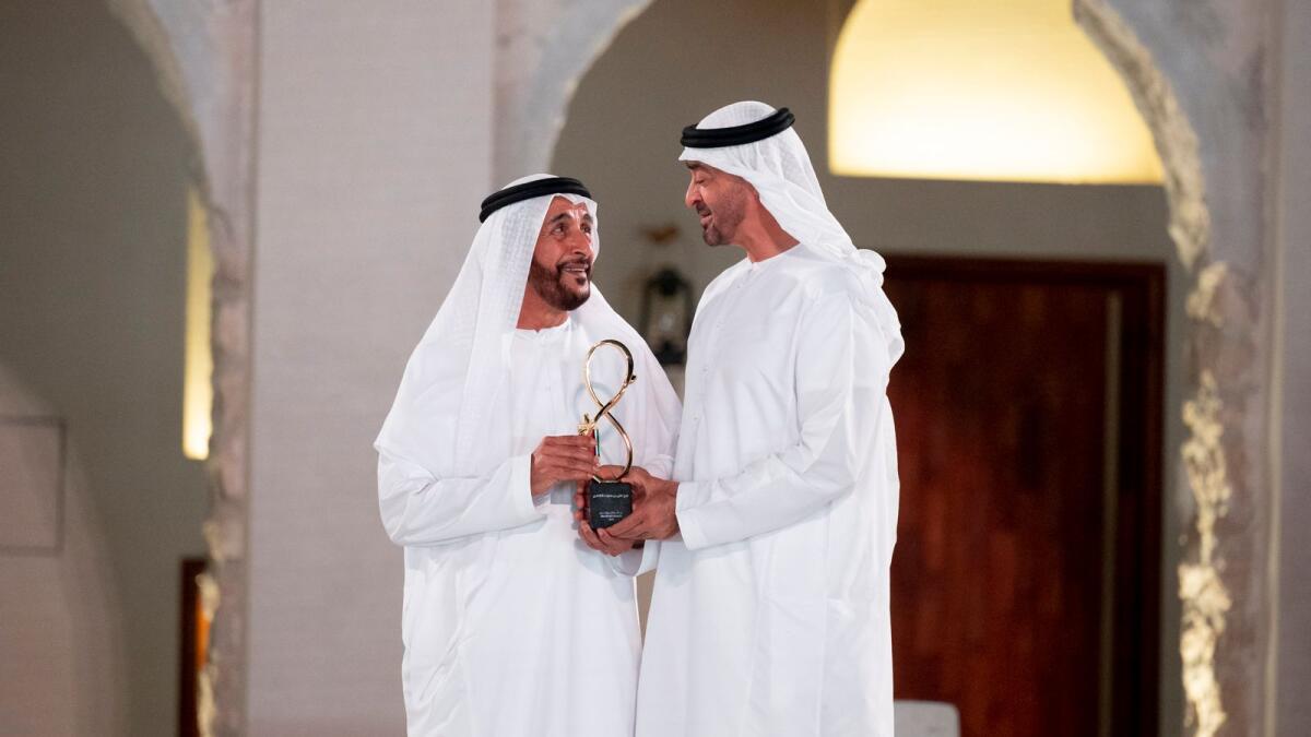 Sheikh Mohamed bin Zayed Al Nahyan presents an award to Faraj bin Hamooda.
