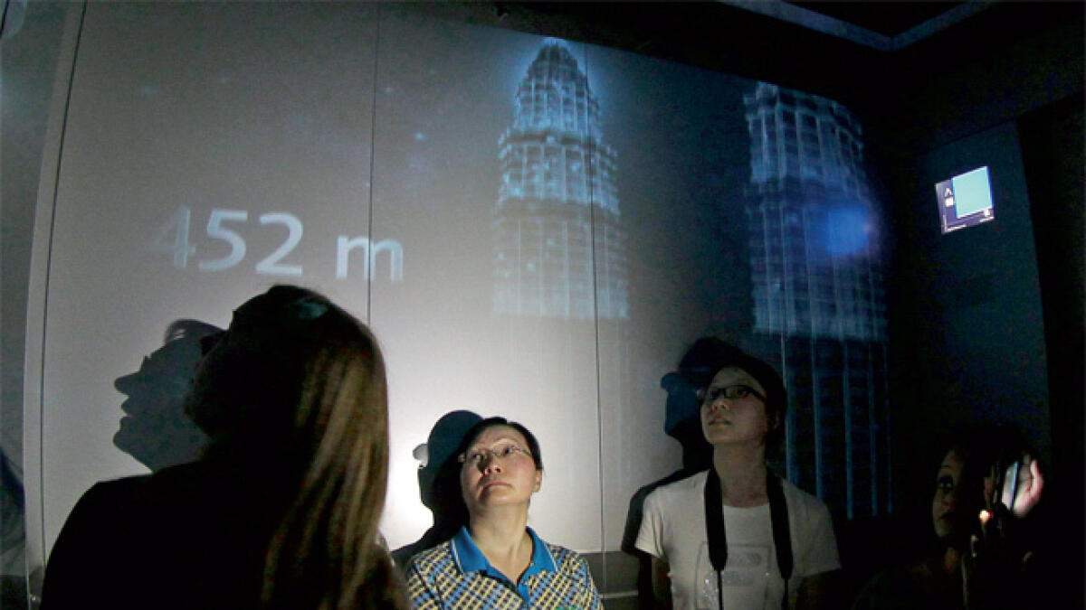 Express lift: Visitors being shown a short movie about the Burj Khalifa while in a high-speed elevator taking them to At the Top, Burj Khalifa SKY.