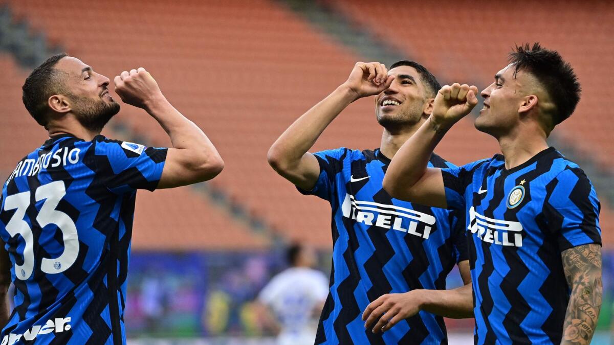 (From left) Inter Milan's Danilo D'Ambrosio, Achraf Hakimi and Lautaro Martinez celebrate after Lautaro scored a penalty during the Italian Serie A match against Sampdoria. — AFP