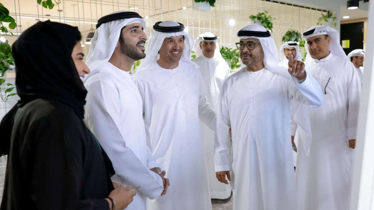 Sheikh Hamdan shares a light moment with officials during his visit to the Department of Economy and Tourism on Monday.