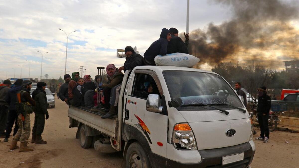 Evacuation buses of fighters and families start to leave Aleppo