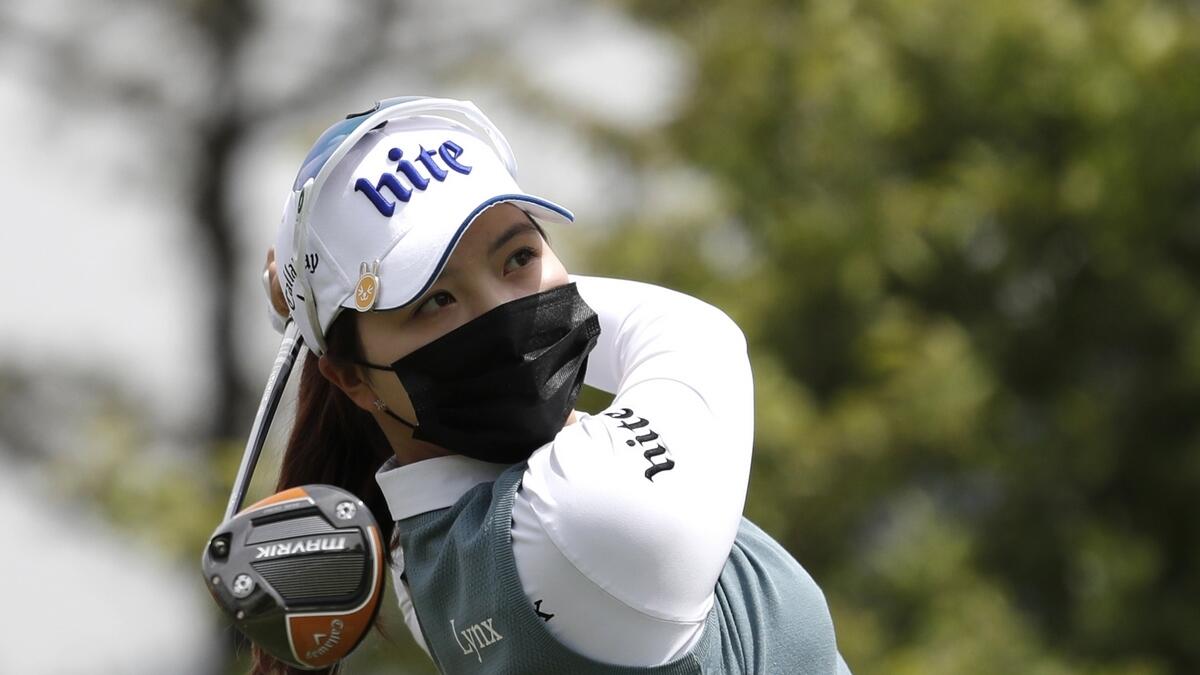 Wearing a face mask, Choi Ye-rim of South Korea watches her tee shot on the first hole during the first round of the KLPGA Championship at the Lakewood Country Club in Yangju, South Korea, on Thursday. (AP)