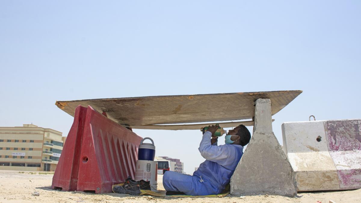 A worker takes mid-day break under shade at a construction site in Dubai, United Arab Emirates.  Photo: Shihab/Khaleej Times