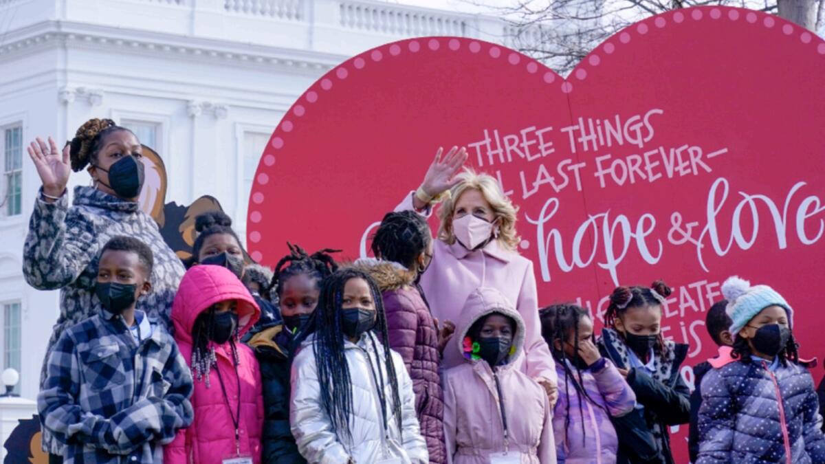 First lady Jill Biden poses for a photo with Aiton Elementary School students and staff as she welcomes school children to the White House in Washington to celebrate Valentine's Day. — AP