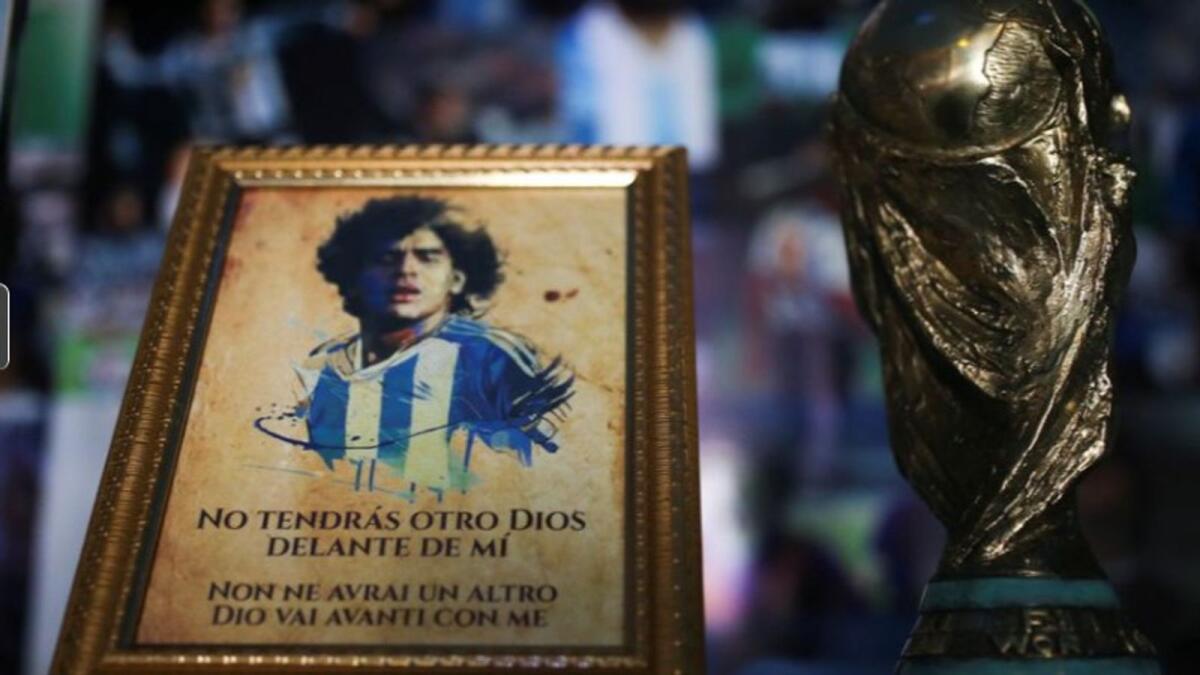 A picture of Diego Maradona and a replica of the World Cup trophy seen in the church. (Reuters)