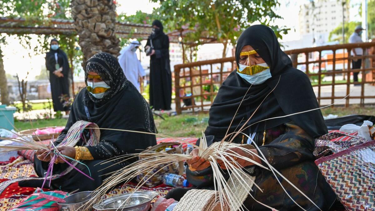 Emirati women prepare handicrafts.
