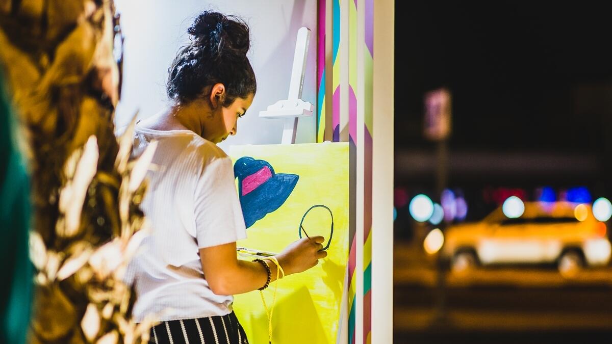 Visitors engaged with art during the ‘I’m loving Street Art’ event at Boxpark in Dubai.-Photo by Neeraj Murali