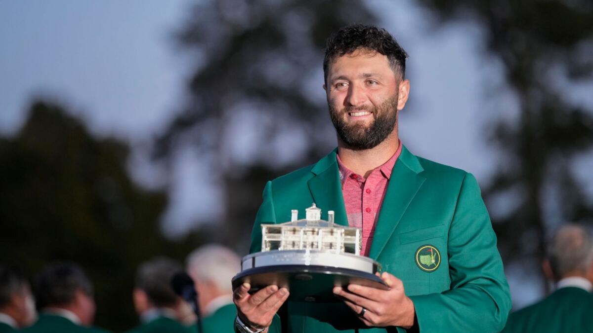 Spain's Jon Rahm lifts the 2023 Master Trophy, a three-dimensional depiction of the clubhouse  at Augusta. He also took home $3.24 million. -AFP