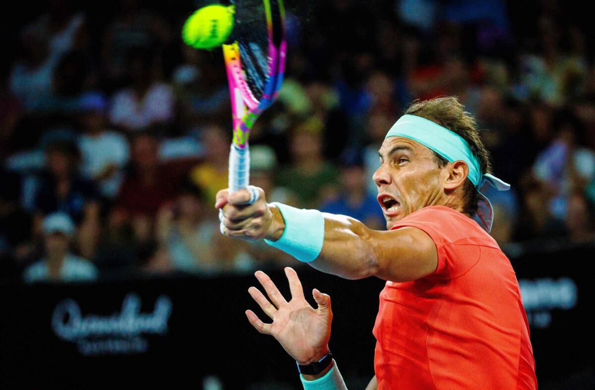 Spain''s Rafael Nadal hits a return during the doubles match at the Brisbane International on Sunday. Nadal and his partner Marc Lopez lost to Australia's Max Purcell and Jordan Thompson. — AFP