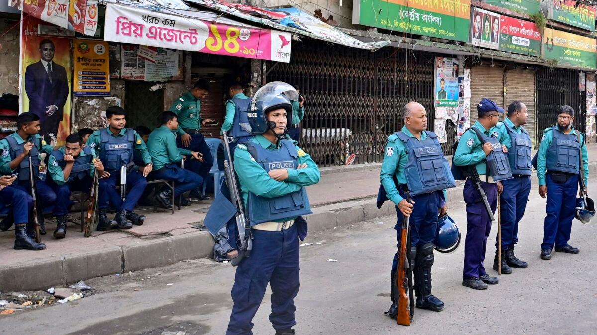 Police personnel stand guard in front of the Bangladesh Nationalist Party (BNP) headquarters in Dhaka during a nationwide strike called by party activists. — AFP file