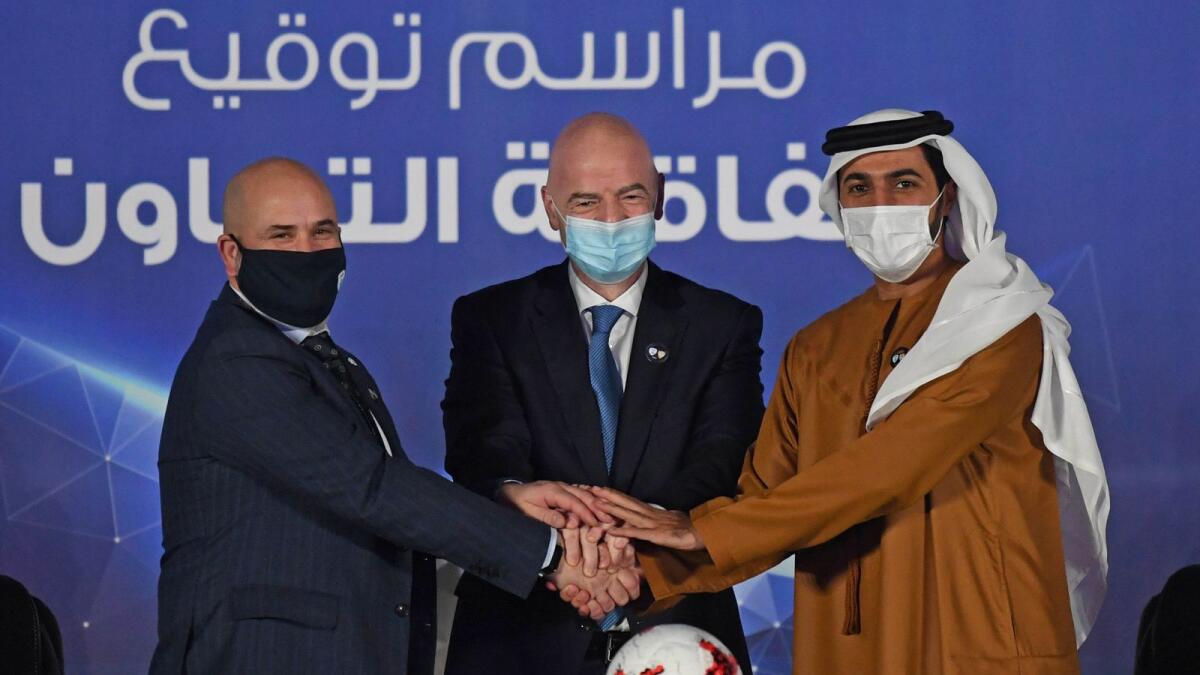 Sheikh Rashid bin Humaid Al Nuaimi, president of the UAEFA, Oren Hasson, president of the Israel Football Association, with Gianni Infantino, president of Fifa, after the two countries signed a football deal in Dubai on Monday. (UAEFA)