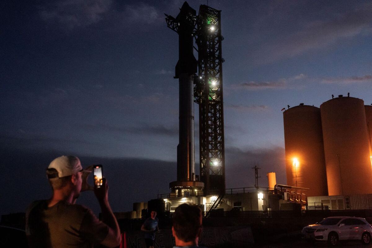 Spectators gather to watch the SpaceX Starship on its Boca Chica launchpad after the US Federal Aviation Administration granted licence allowing Elon Musk's SpaceX to launch the rocket to orbit for the first time, near Brownsville, Texas, on Sunday. — Reuters