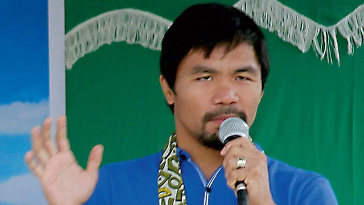 Manny Pacquiao is delivering a speech during the inauguration of a low-cost housing village owned and named after him in Glan town, Sarangani province.