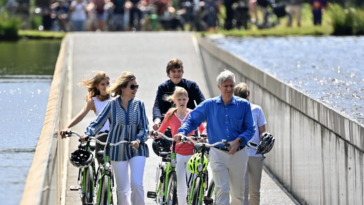 Belgian royal family, from left, Princess Elisabeth, Queen Mathilde, Prince Gabriel, Princess Eleonore and King Philippe and Prince Emmanuel pose for a photo as they ride their bicycles during a royal visit to the Bokrijk park and open-air museum in Genk, Belgium. Photo:  AP