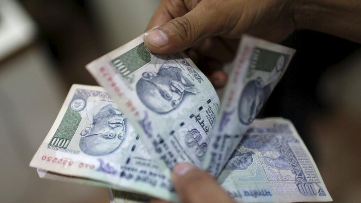 Indian rupee falls to 1-month low as shares extend losses