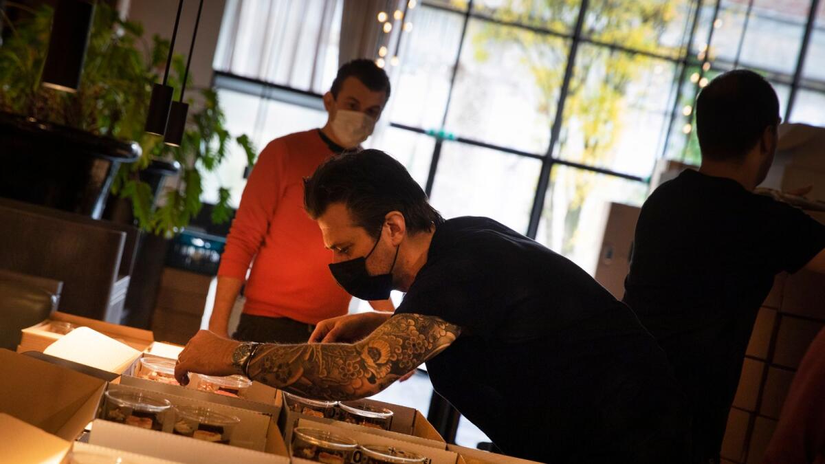 Chef Sergio Herman, centre, puts the finishing touches on nearly 600 take-away orders at his restaurant, Le Pristine in Antwerp.