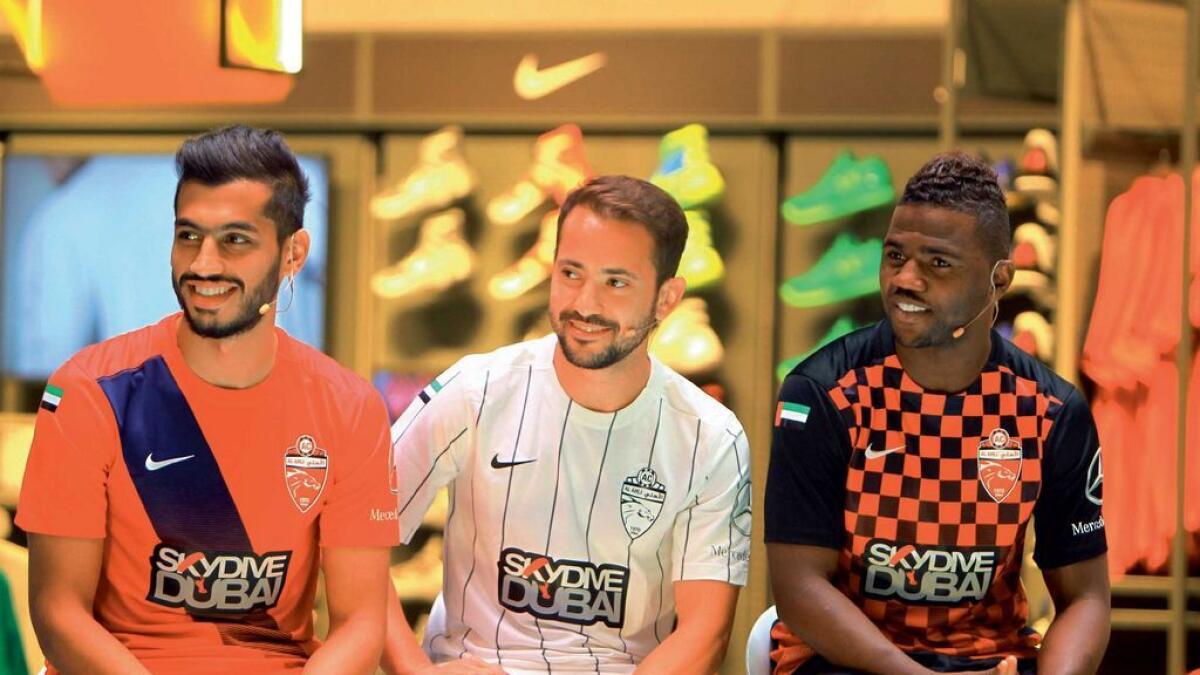 Al Ahli’s Majed Hassan, Everton Ribeiro and Ismail Al Hammadi at the unveiling of the team kit for the forthcoming seasonat Sun and Sand Sports Store in Dubai Mall on Sunday.  