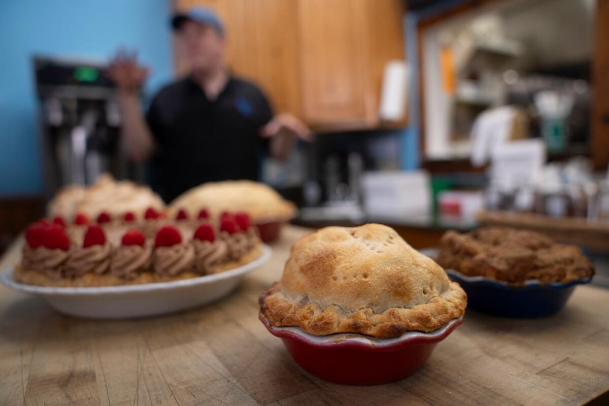 Manager Stephen Jarrett prepares pies on a counter at Michele's Pies, on Wednesday in Norwalk, Connecticut. — AP