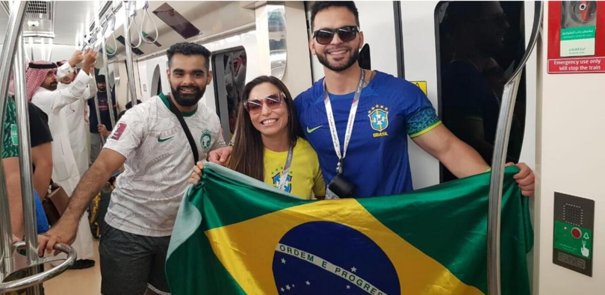 Samuel and his partner, Ana, pose with a Saudi fan during the World Cup in Qatar. — Photo by Rituraj Borkakoty