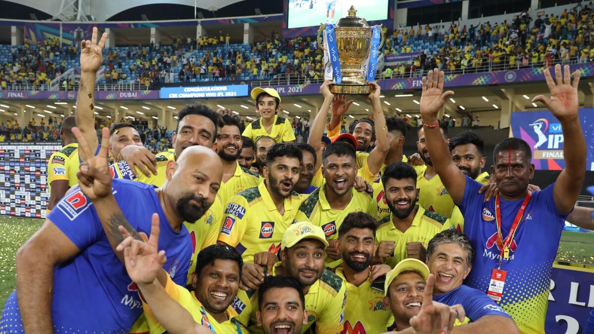 Chennai Super Kings players celebrate with the trophy after winning the 2021 IPL final against Kolkata Knight Riders at the Dubai International Stadium on October 15. (BCCI)