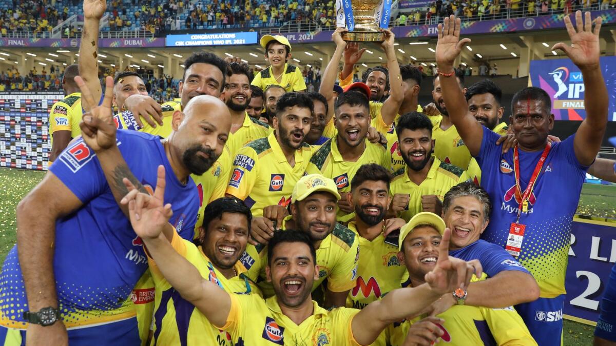 Chennai Super Kings players celebrate with the trophy after winning the 2021 IPL final against Kolkata Knight Riders at the Dubai International Stadium on October 15. (BCCI)