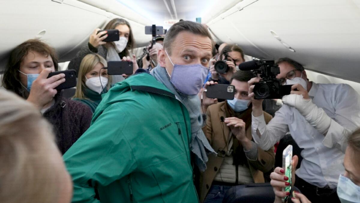 Alexei Navalny is surrounded by journalists inside the plane prior to his flight to Moscow in the Airport Berlin Brandenburg (BER) in Schoenefeld, near Berlin. AP