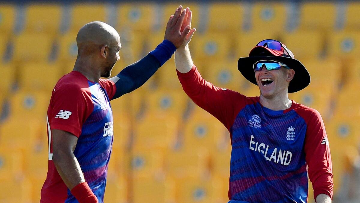 England's Tymal Mills celebrates a wicket with Eoin Morgan. (ANI)