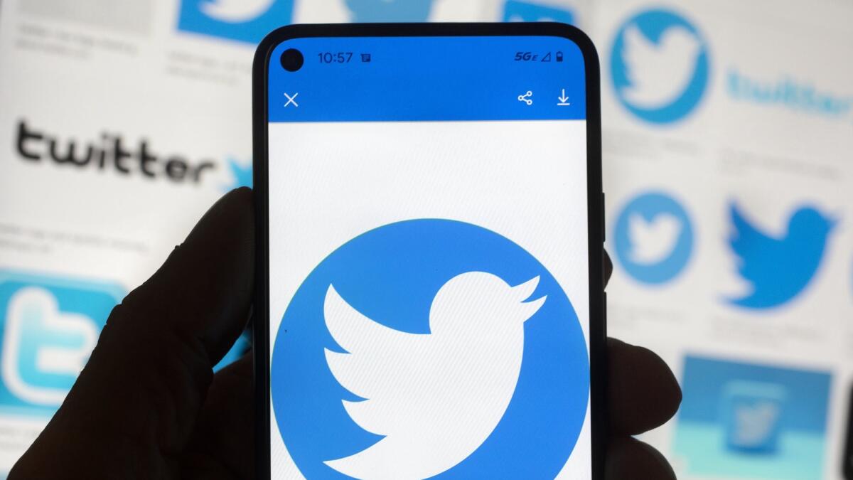 The Twitter logo is seen on a cell phone on October 14, 2022 in Boston. — AP