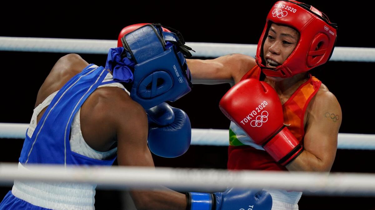 India’s Mery Kom Hmangte (right) exchanges punches with Miguelina Hernandez Garcia, of the Dominican Republic, during their women’s flyweight 51-kg boxing match. — AP
