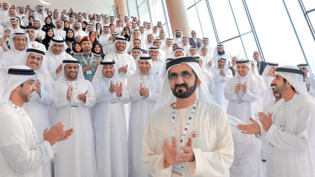 VISION RECHARGED: Sheikh Mohammed, Sheikh Hamdan bin Mohammed bin Rashid Al Maktoum, Crown Prince of Dubai, ministers and officials applaud after the signing of the National Charter.-Wam 