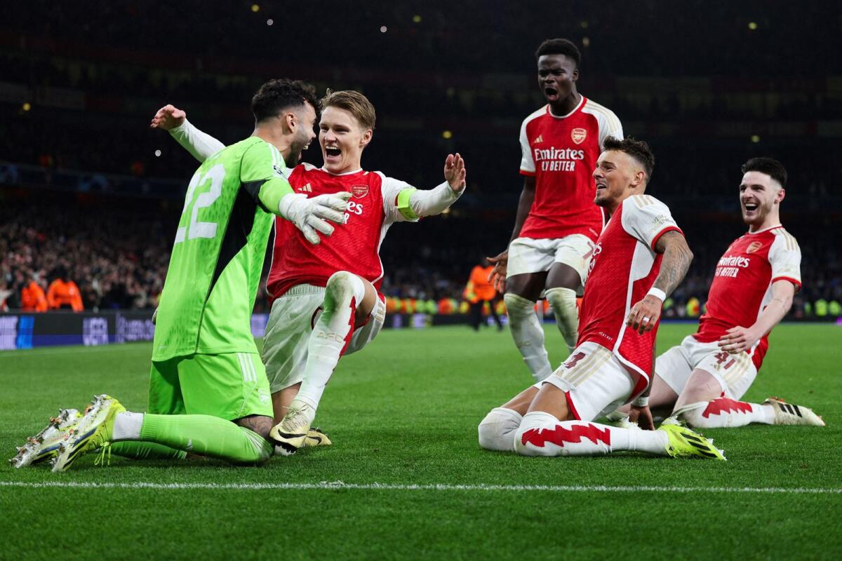Arsenal goalkeeper David Raya celebrates with his teammates after winning the penalty shootout against Porto. — AFP