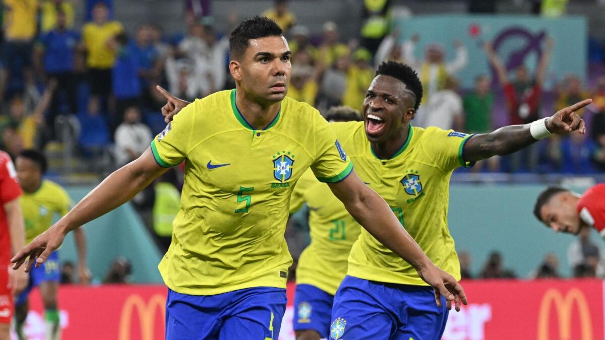Brazil's midfielder Casemiro (L) celebrates with Brazil's forward Vinicius Junior after he scored his team'swinning goal during the Qatar 2022 World Cup Group G football match between Brazil and Switzerland at Stadium 974 in Doha on November 28, 2022. Photo: AFP