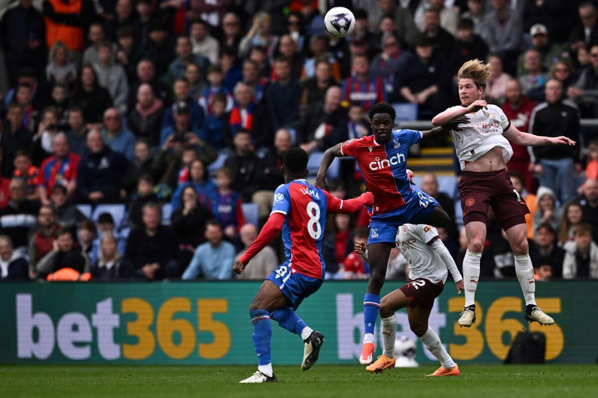 Manchester City's Belgian midfielder Kevin De Bruyne fights for the ball with Crystal Palace's French midfielder Naouirou Ahamada (C) during the English Premier League at Selhurst Park in south London on Saturday. - AFP