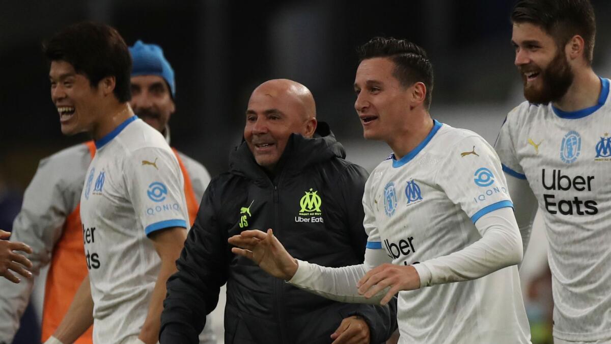 Marseille's Florian Thauvin (centre right) celebrates with Marseille's coach Jorge Sampaoli after scoring a goal.— AP