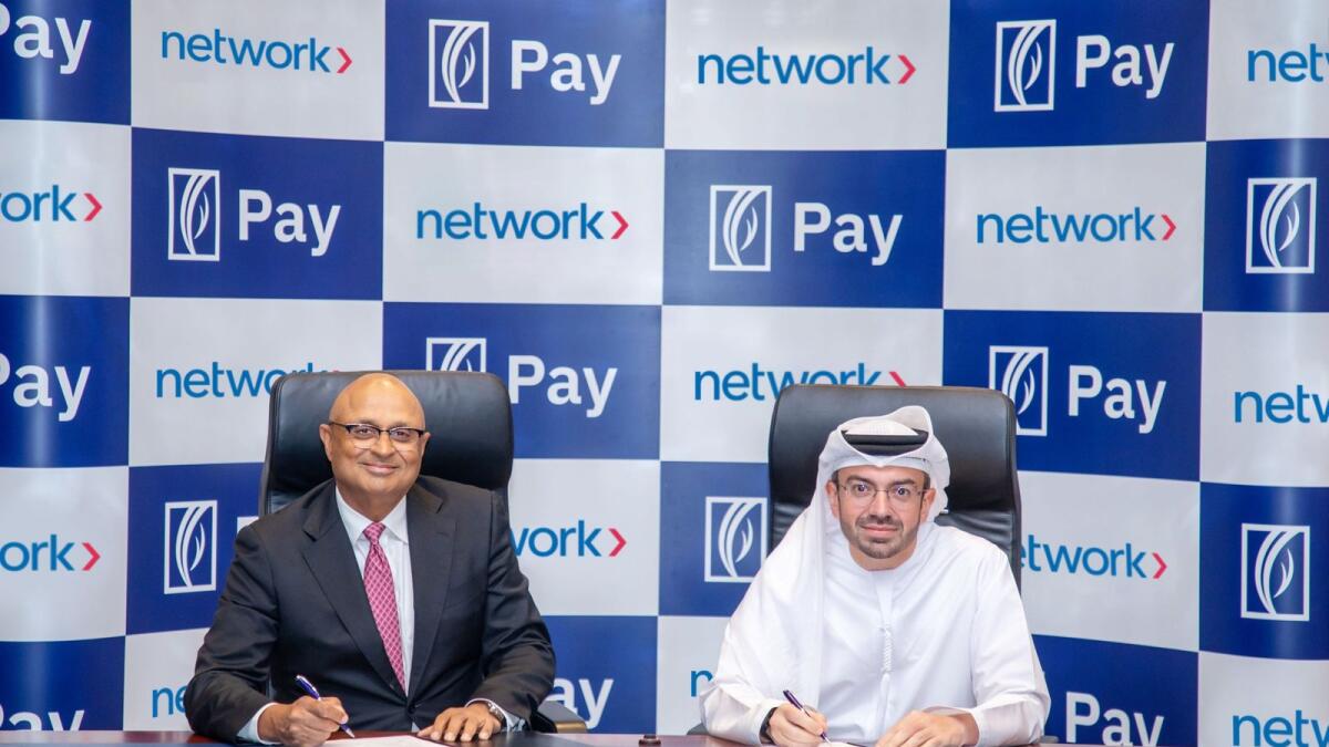 Nandan Mer, group CEO Network International, and Ahmed Al Qassim, senior executive vice-president and group head, corporate and institutional banking at Emirates NBD, signing the agreement in Dubai on Thursday. — Supplied photo