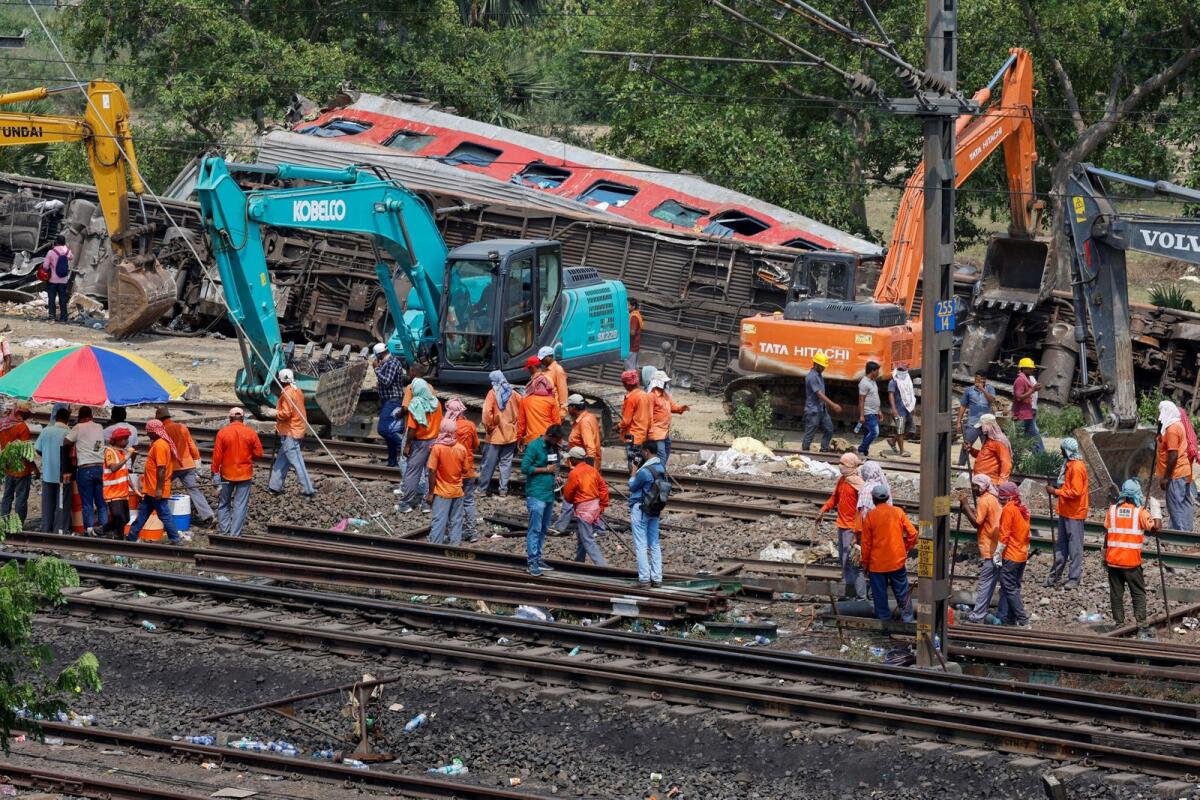 Heavy machinery remove damaged coaches from the railway tracks at the site of a train collision following the accident in Balasore district in the eastern state of Odisha, India, on Sunday. Photo: Reuters