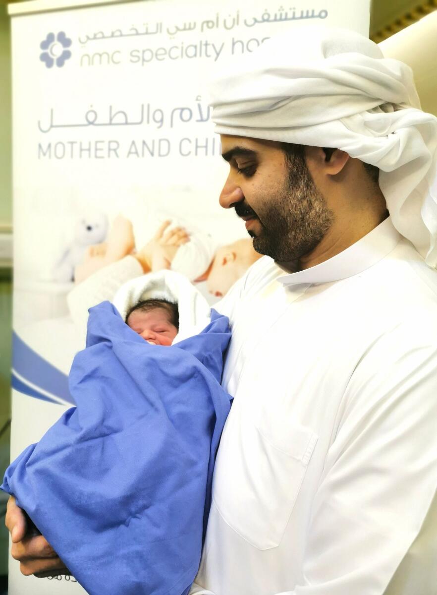 Abdulla Husain with his new born on the first day of Eid