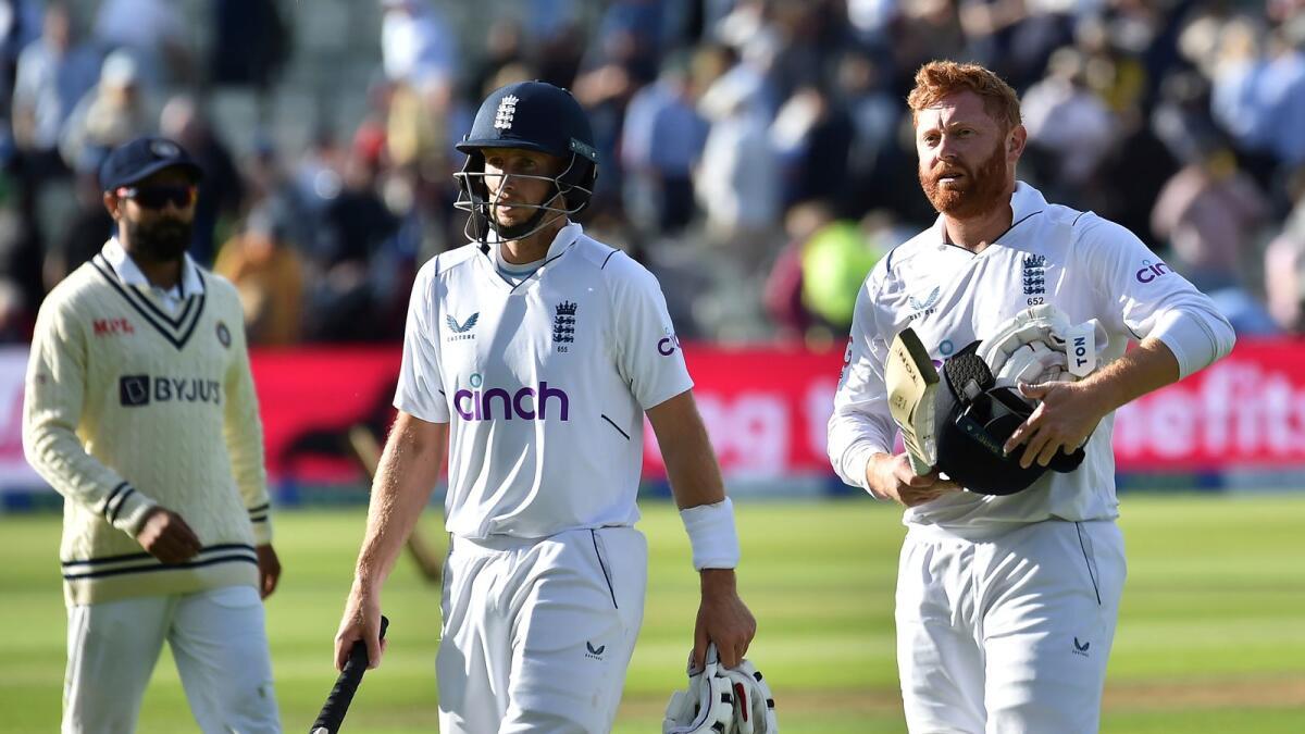 England's Jonny Bairstow (right) walks off the field with batting partner Joe Root at the end of play on the fourth day of the fifth Test against India. (AP)