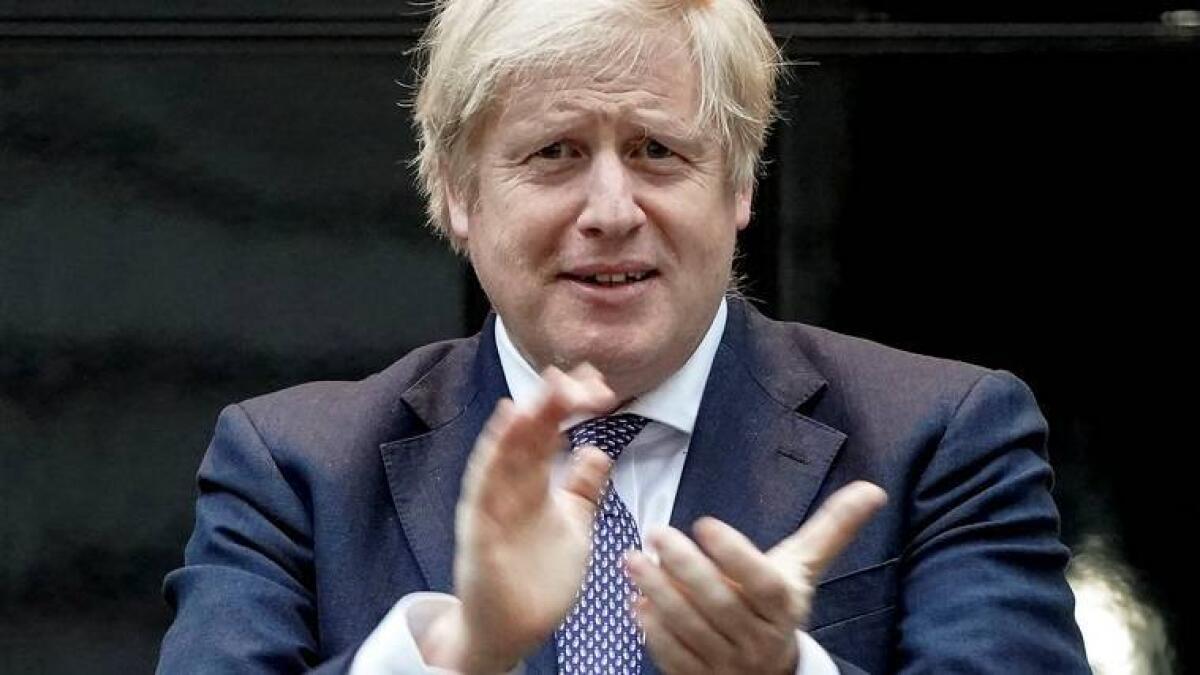 Britain's Prime Minister Boris Johnson takes part in a 'Clap for Carers' campaign in support of the NHS, following the outbreak of the coronavirus disease, at 10 Downing Street in London on April 30, 2020