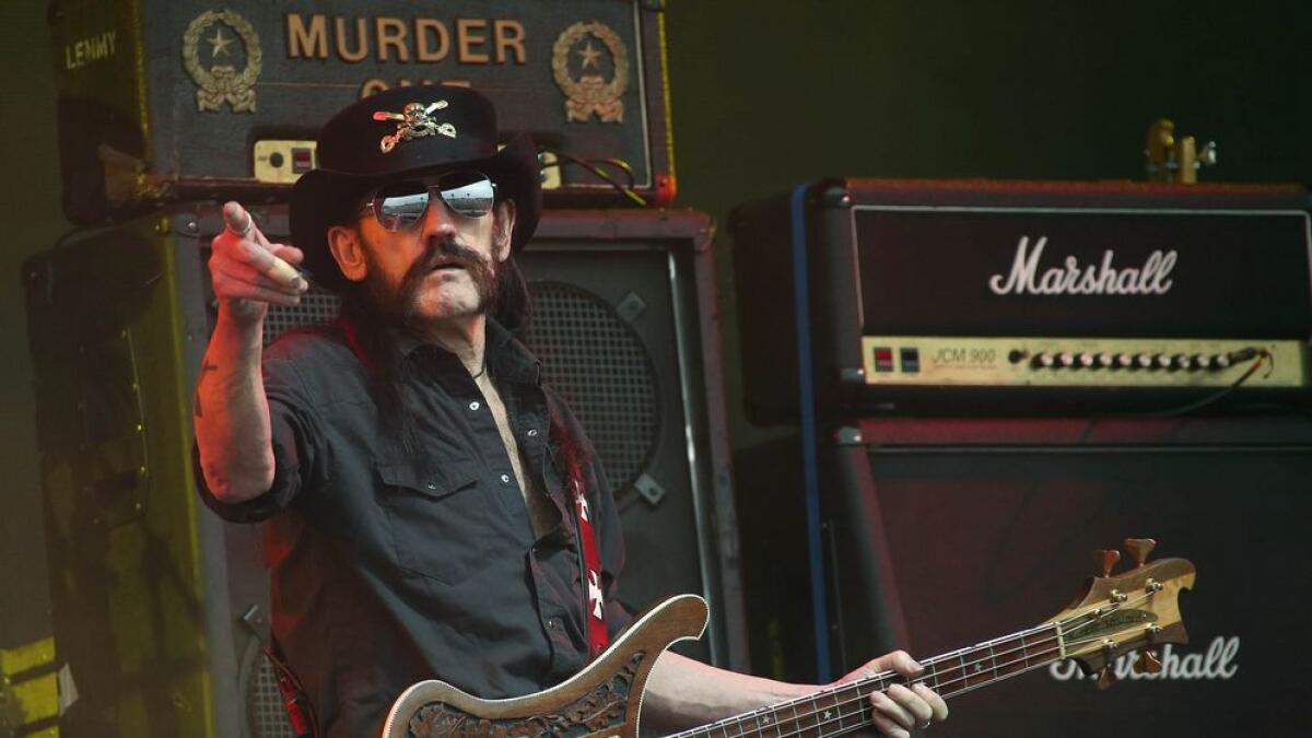 Lemmy Kilmister performing on stage.