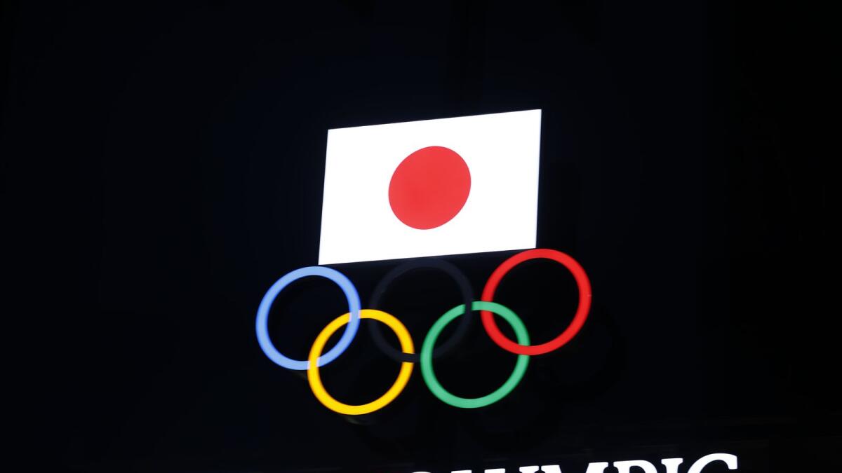 Olympic rings and a Japan flag are seen in Tokyo. (AFP)