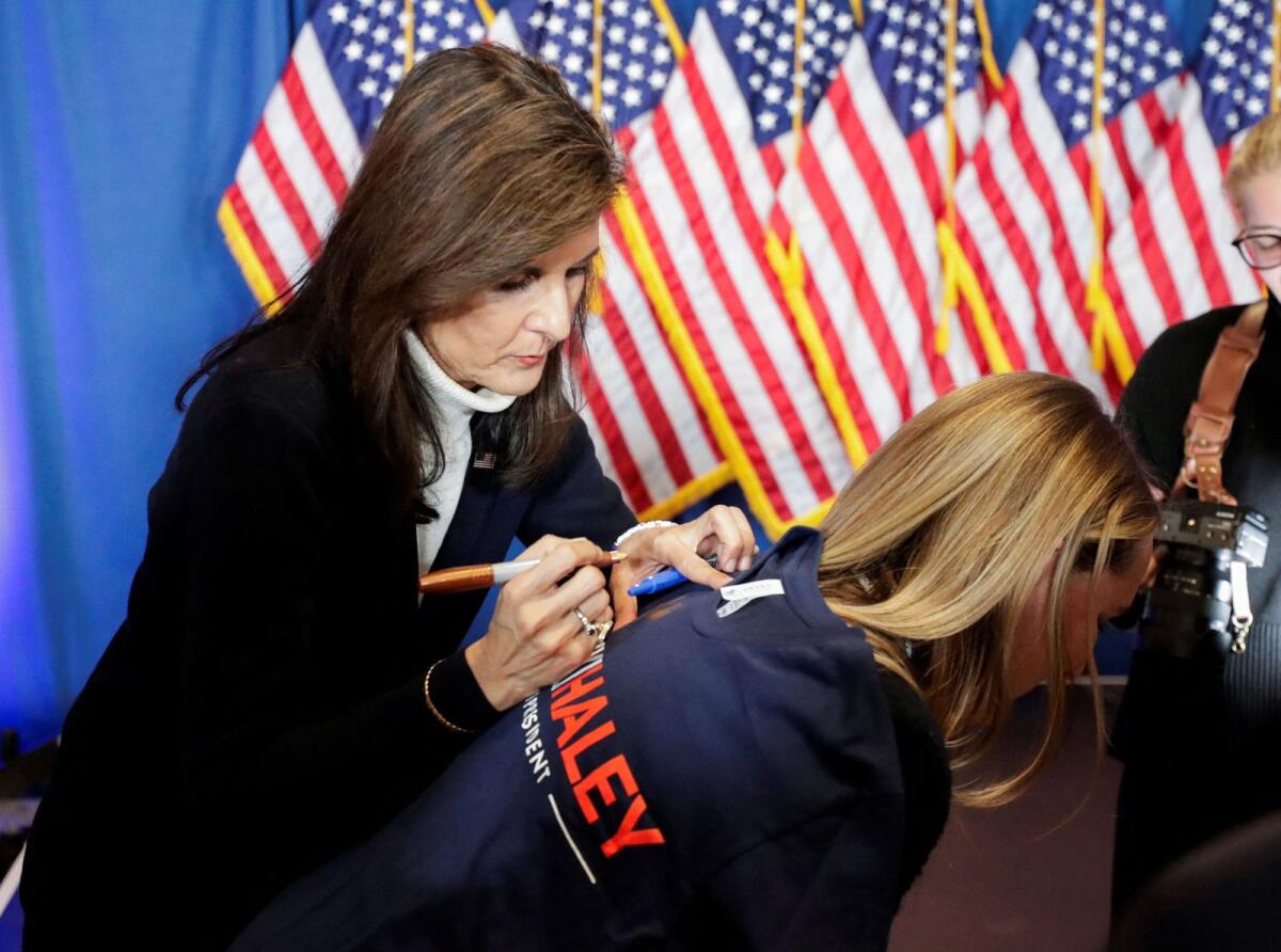 Republican presidential candidate and former US ambassador to the United Nations Nikki Haley signs a t-shirt following a campaign event in Portland, Maine, US, on March 3, 2024. — Reuters