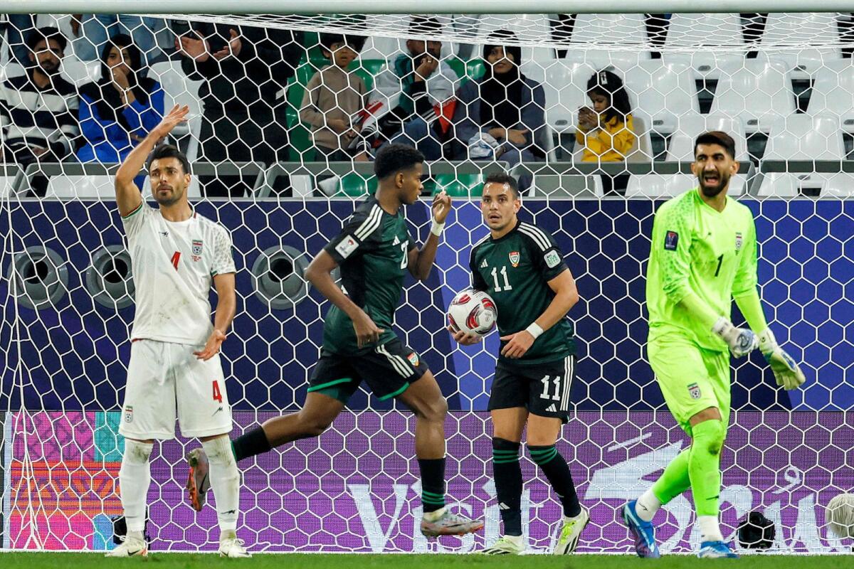 UAE's forward Yahya Al-Ghassani (second left) celebrates after scoring a goal during the Asian Cup match against Iran in Doha. — AFP