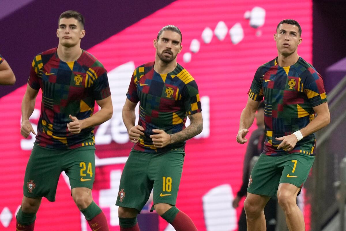Portugal's Antonio Silva, left, Portugal's Ruben Neves, center, and Portugal's Cristiano Ronaldo warm up prior to the World Cup round of 16 match. Photo: AP