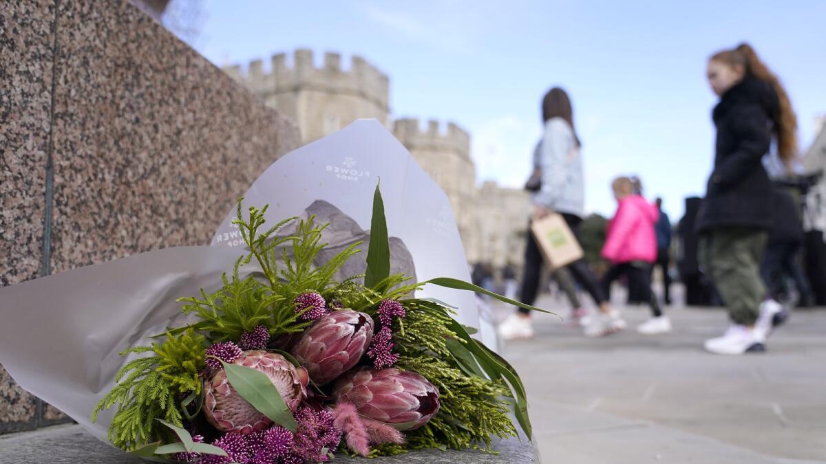 Flowers are left outside Windsor Castle. — AP
