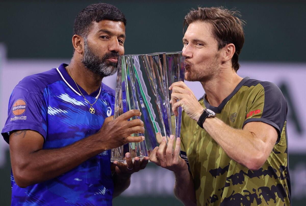 Rohan Bopanna of India and Matthew Ebden of Australia celebrate with the winners trophy after defeating Wesley Koolhof of Netherlands and Neal Skupski of Great Britain. — AFP